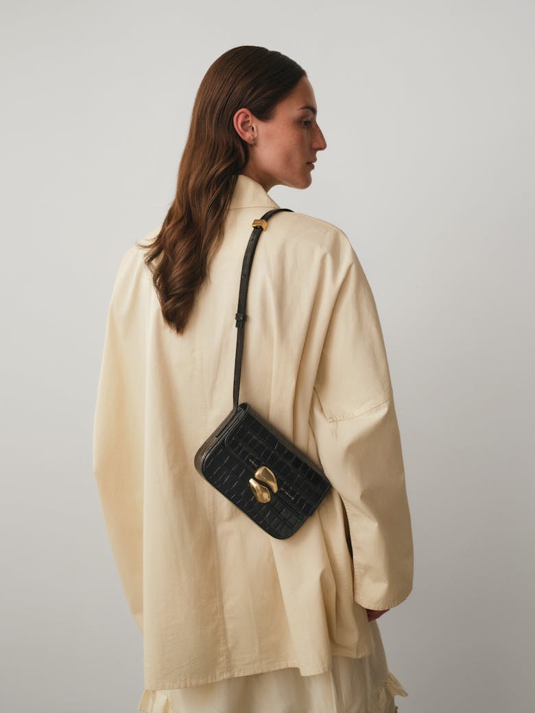 Flap Bag with Sculptural Seal “glossy black crocodile”